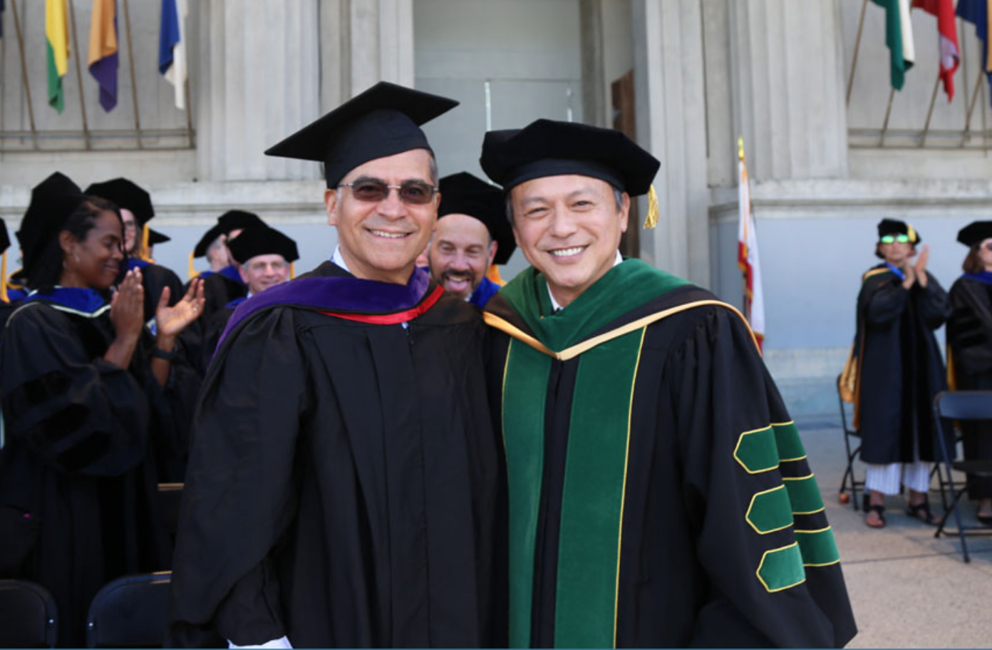 Xavier Becerra and UC Berkeley Public Health Dean Michael C. Lu wearing graduation apparel